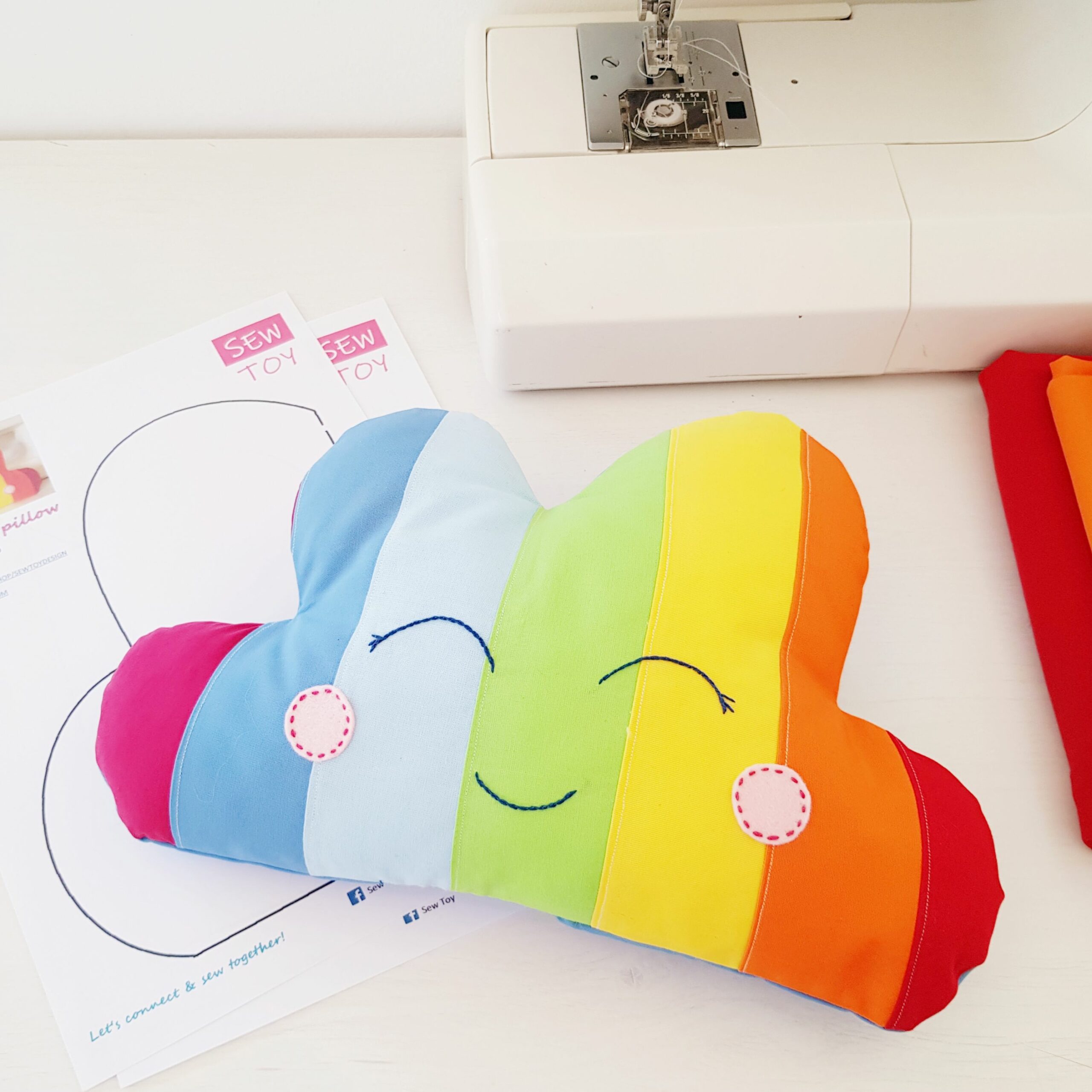 Rainbow pillow cloud sewing pattern for beginners with a smiley face